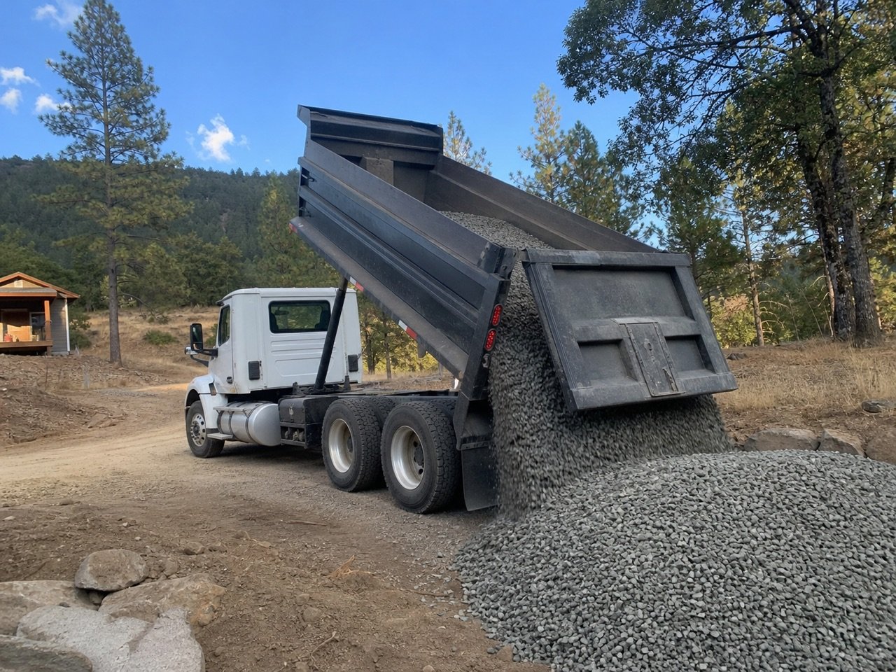 Dump truck unloading crushed rock at a Southern Oregon jobsite